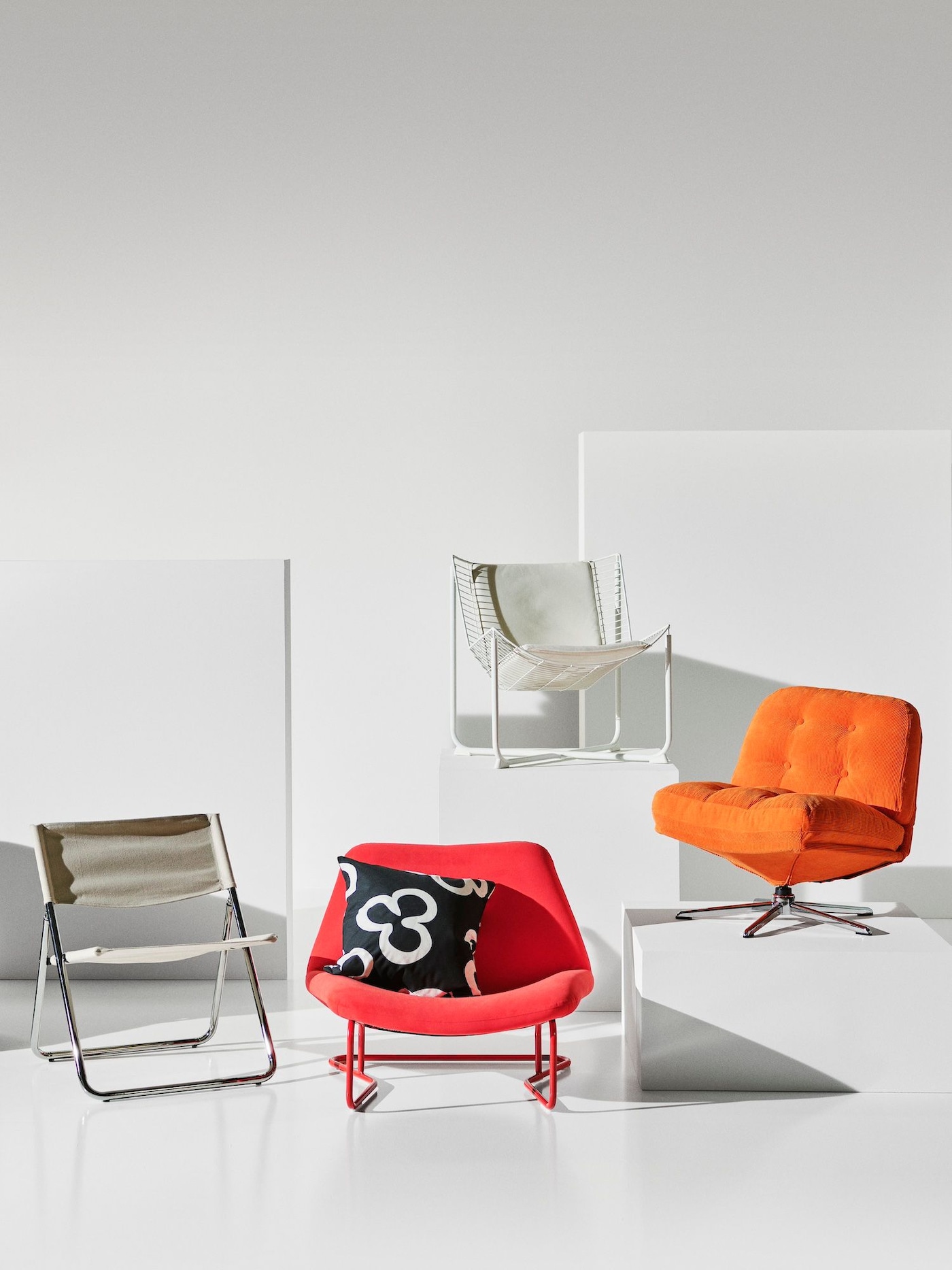 A white studio space with objects from the latest Nytillverkad collection, positioned on white podiums.