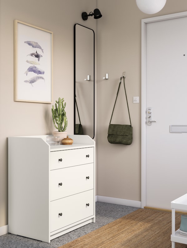A white HAUGA chest of 3 drawers