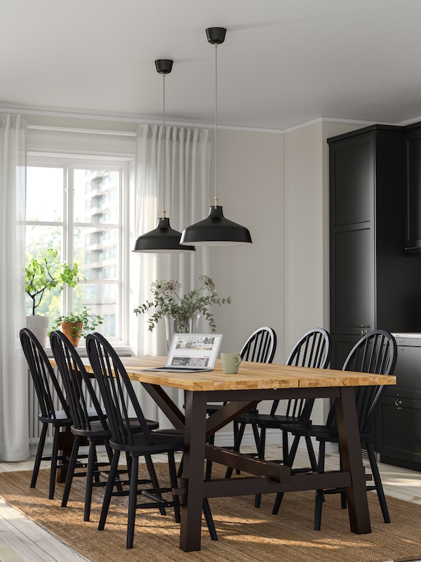 An acacia/black SKOGSTA dining table
