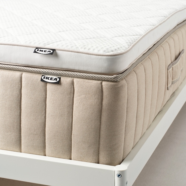 A white NYLÄGET mattress pad