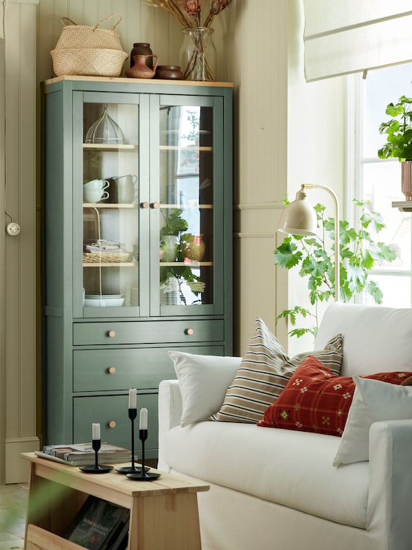 A grey-green/light brown stained HEMNES glass-door cabinet with 3 drawers
