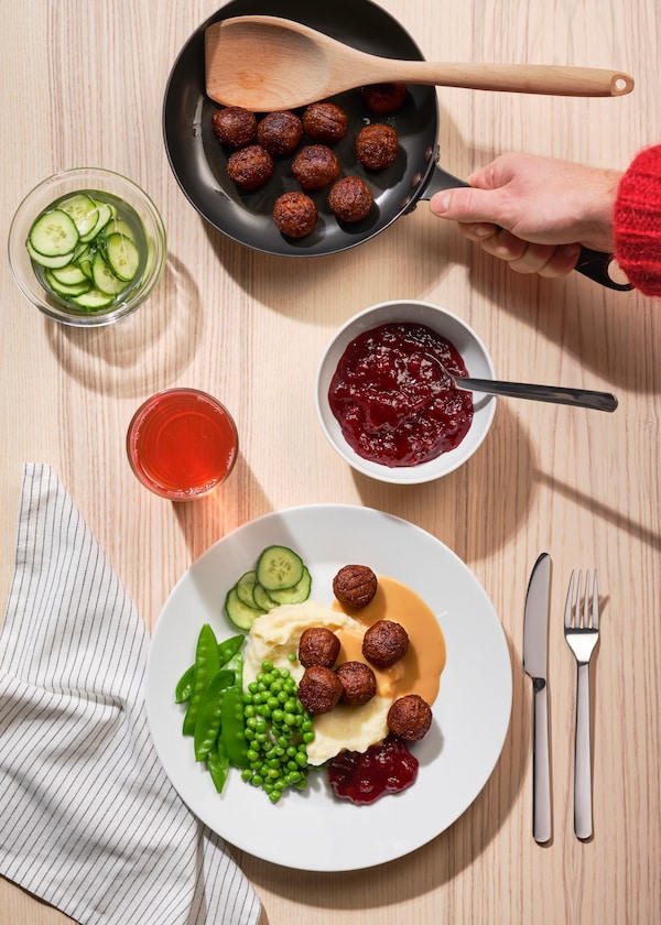 Swedish meatballs on a plate with lingonberry on the side.