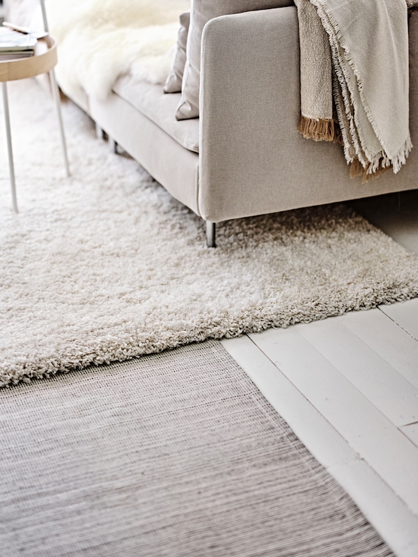 An off-white/grey-beige GUNNEMOR throw