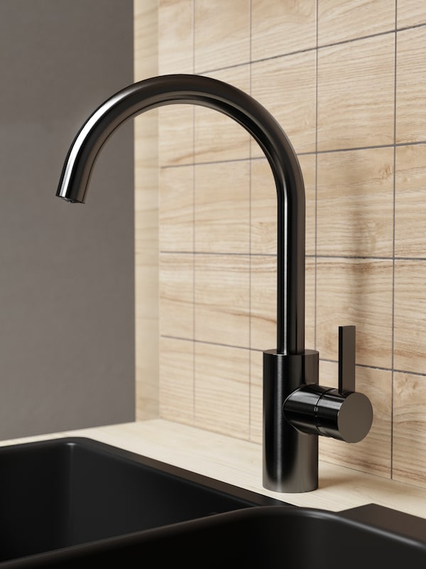 A brushed black metal DELSJÖN kitchen mixer tap