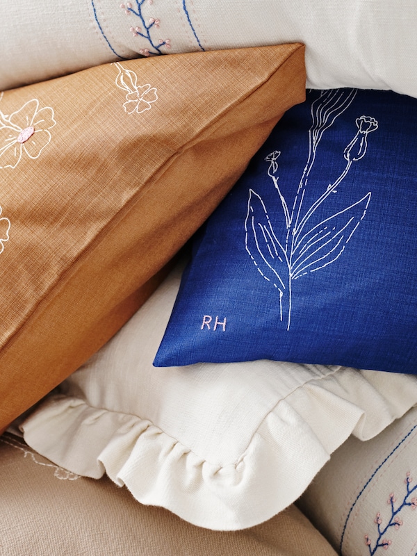 A blue embroidery ÅKERNEJLIKA cushion cover