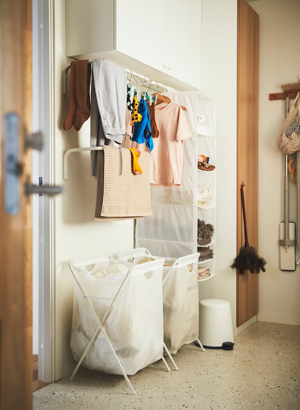 A white JÄLL laundry bag with stand