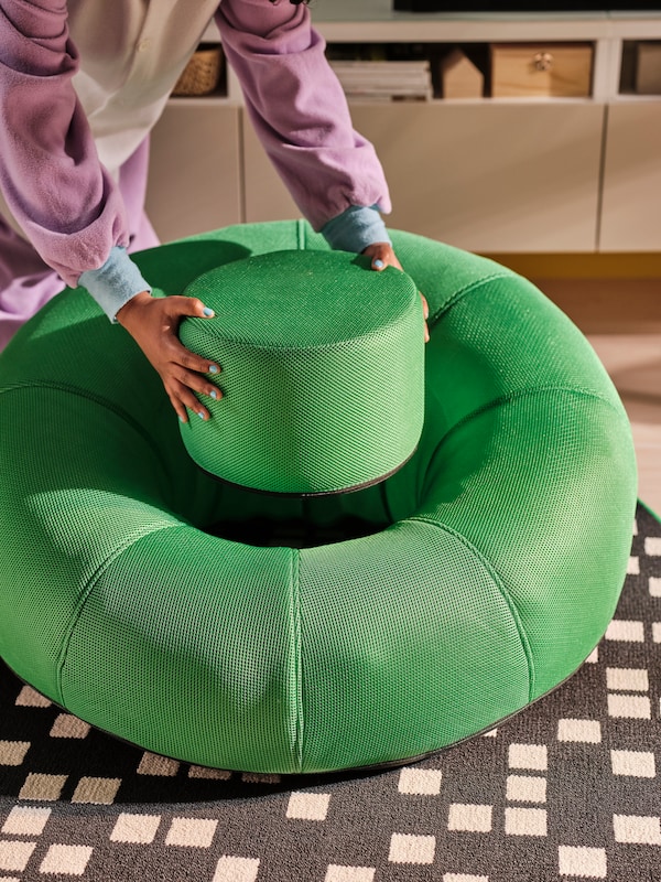 A bright green BRÄNNBOLL inflatable gaming lounge chair