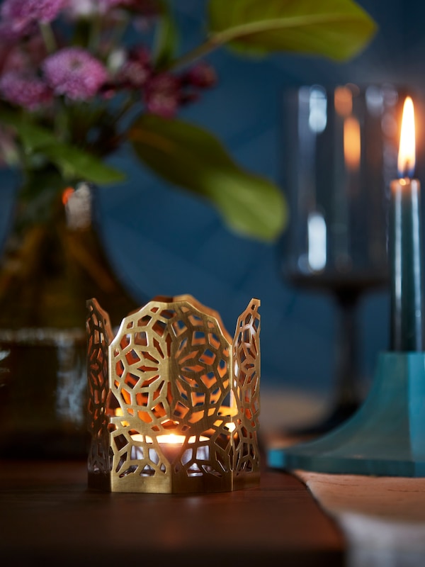 A gold-colour GOKVÄLLÅ tealight holder