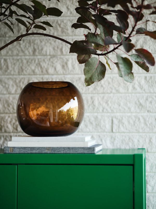 A green STOCKHOLM 2025 cabinet with 2 doors in the living room