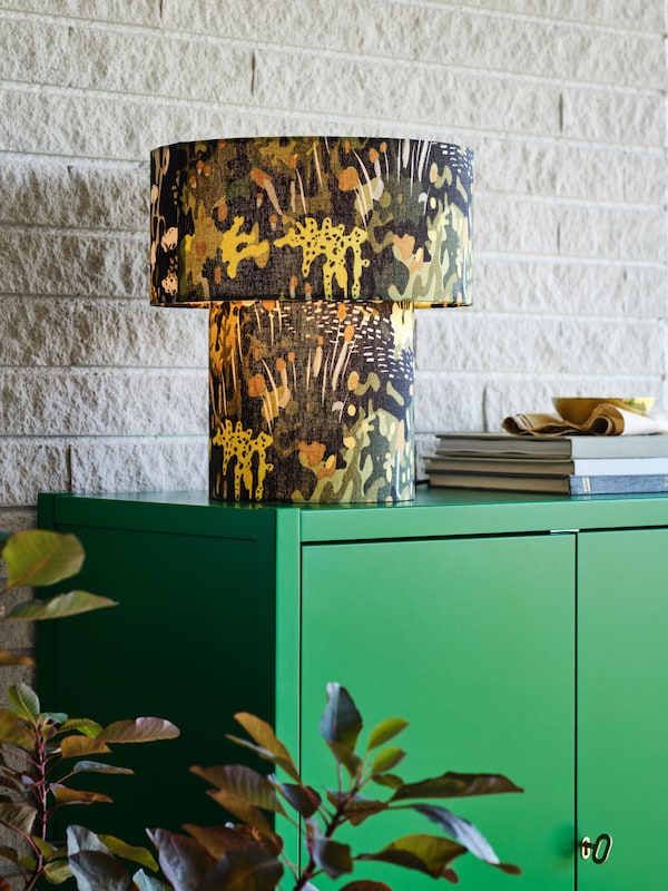 A green STOCKHOLM 2025 cabinet with 2 doors
